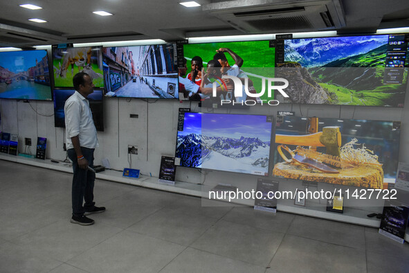 A man is operating a television at an electronic store in Kolkata, India, on July 22, 2024. The budget is boosting the ''Make in India'' cam...