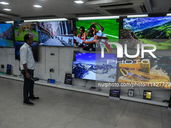 A man is operating a television at an electronic store in Kolkata, India, on July 22, 2024. The budget is boosting the ''Make in India'' cam...