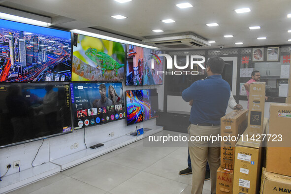 Customers are shopping at an electronic store in Kolkata, India, on July 22, 2024. The budget is boosting the ''Make in India'' campaign by...