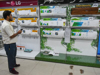 A man is operating an air conditioner at an electronic store in Kolkata, India, on July 22, 2024. The budget is boosting the ''Make in India...