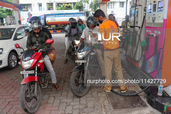 A crowd is gathering at a petrol filling station in Kolkata, India, on July 22, 2024. People are expecting some relief from the budget again...