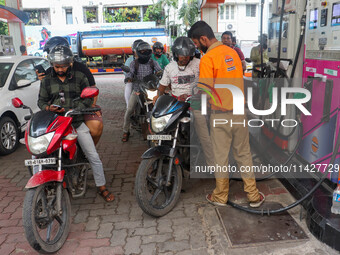 A crowd is gathering at a petrol filling station in Kolkata, India, on July 22, 2024. People are expecting some relief from the budget again...