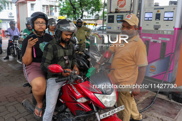 A crowd is gathering at a petrol filling station in Kolkata, India, on July 22, 2024. People are expecting some relief from the budget again...