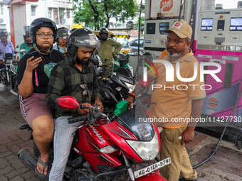 A crowd is gathering at a petrol filling station in Kolkata, India, on July 22, 2024. People are expecting some relief from the budget again...