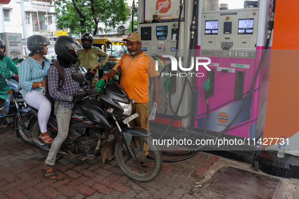 A crowd is gathering at a petrol filling station in Kolkata, India, on July 22, 2024. People are expecting some relief from the budget again...