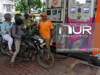 A crowd is gathering at a petrol filling station in Kolkata, India, on July 22, 2024. People are expecting some relief from the budget again...