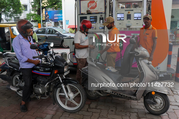 A crowd is gathering at a petrol filling station in Kolkata, India, on July 22, 2024. People are expecting some relief from the budget again...