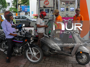 A crowd is gathering at a petrol filling station in Kolkata, India, on July 22, 2024. People are expecting some relief from the budget again...