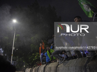 Students from various universities are trying to break through a barrier as they stage a demonstration to commemorate 10 years of Jokowi's g...