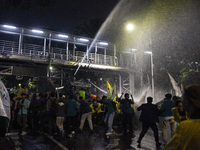 Police are firing water cannons to disperse the students as they are trying to break through the barrier during the demonstration to commemo...