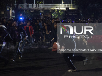 Police are firing water cannons to disperse the students as they are trying to break through the barrier during the demonstration to commemo...