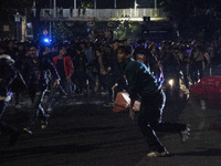 Police are firing water cannons to disperse the students as they are trying to break through the barrier during the demonstration to commemo...