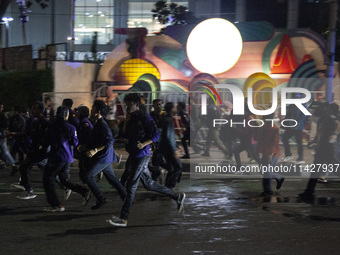 Police are firing water cannons to disperse the students as they are trying to break through the barrier during the demonstration to commemo...