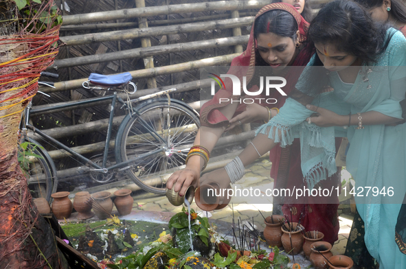 Devotees are offering prayers at Chadmoni Shiva Temple in Siliguri, India, on July 22, 2024. 