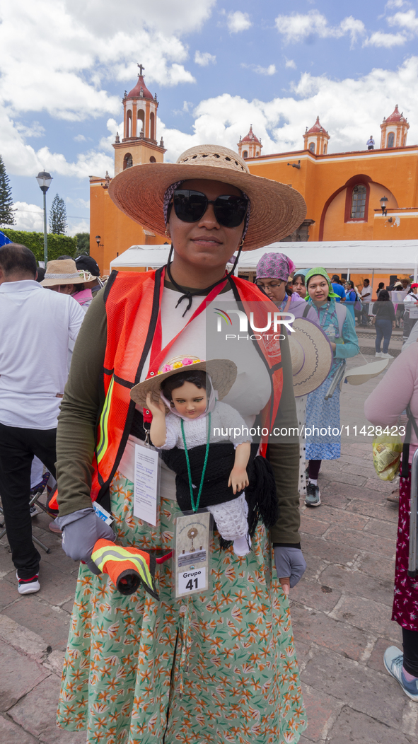 A pilgrim woman from the Sierra Gorda of Queretaro is posing for a photo while arriving at the Municipality of San Juan del Rio to continue...