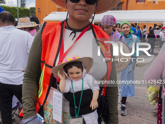 A pilgrim woman from the Sierra Gorda of Queretaro is posing for a photo while arriving at the Municipality of San Juan del Rio to continue...