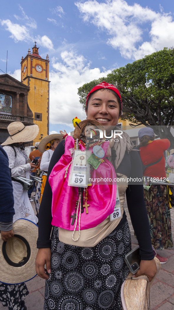 A pilgrim woman from the Sierra Gorda of Queretaro is posing for a photo while arriving at the Municipality of San Juan del Rio to continue...