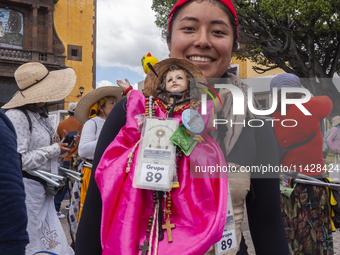 A pilgrim woman from the Sierra Gorda of Queretaro is posing for a photo while arriving at the Municipality of San Juan del Rio to continue...