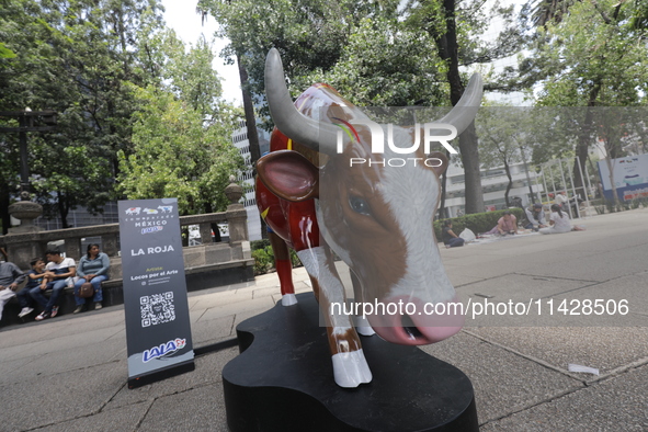 A fiberglass cow painting by an artist is being seen during the inauguration of the 'Cowparade Mexico 2024' on Avenida Reforma in Mexico Cit...