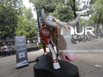 A fiberglass cow painting by an artist is being seen during the inauguration of the 'Cowparade Mexico 2024' on Avenida Reforma in Mexico Cit...