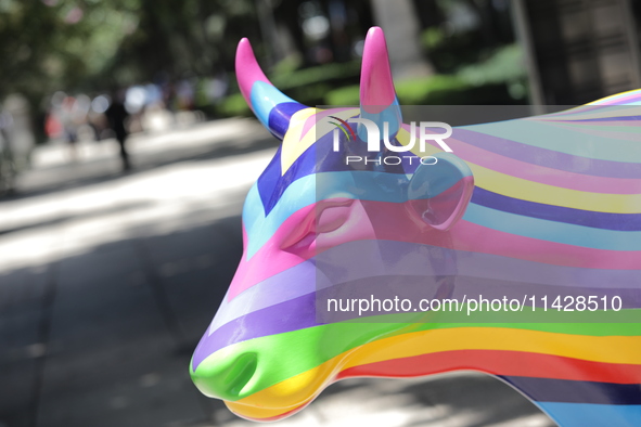 A fiberglass cow painting by an artist is being seen during the inauguration of the 'Cowparade Mexico 2024' on Avenida Reforma in Mexico Cit...