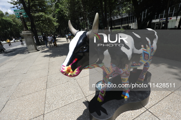 A fiberglass cow painting by an artist is being seen during the inauguration of the 'Cowparade Mexico 2024' on Avenida Reforma in Mexico Cit...