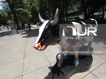 A fiberglass cow painting by an artist is being seen during the inauguration of the 'Cowparade Mexico 2024' on Avenida Reforma in Mexico Cit...