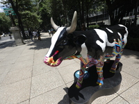 A fiberglass cow painting by an artist is being seen during the inauguration of the 'Cowparade Mexico 2024' on Avenida Reforma in Mexico Cit...