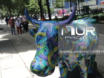 A fiberglass cow painting by an artist is being seen during the inauguration of the 'Cowparade Mexico 2024' on Avenida Reforma in Mexico Cit...