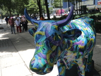 A fiberglass cow painting by an artist is being seen during the inauguration of the 'Cowparade Mexico 2024' on Avenida Reforma in Mexico Cit...