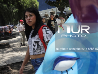 A woman is being seen during the inauguration of the 'Cowparade Mexico 2024' on Avenida Reforma in Mexico City, Mexico, on July 21, 2024. Co...