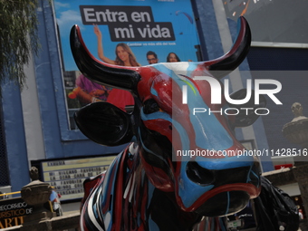 A fiberglass cow painting by an artist is being seen during the inauguration of the 'Cowparade Mexico 2024' on Avenida Reforma in Mexico Cit...