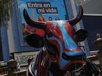 A fiberglass cow painting by an artist is being seen during the inauguration of the 'Cowparade Mexico 2024' on Avenida Reforma in Mexico Cit...