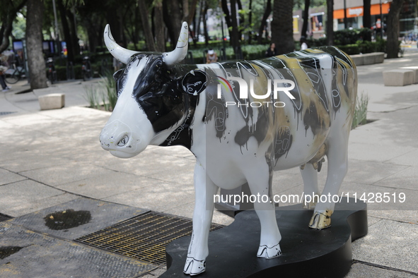 A fiberglass cow painting by an artist is being seen during the inauguration of the 'Cowparade Mexico 2024' on Avenida Reforma in Mexico Cit...