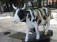 A fiberglass cow painting by an artist is being seen during the inauguration of the 'Cowparade Mexico 2024' on Avenida Reforma in Mexico Cit...