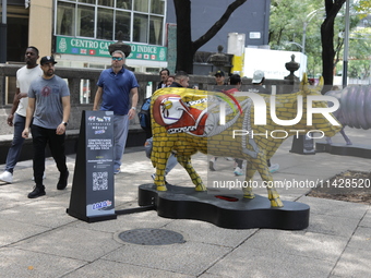 Persons are attending the inauguration of the 'Cowparade Mexico 2024' on Avenida Reforma in Mexico City, Mexico, on July 21, 2024. CowParade...