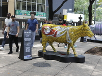 Persons are attending the inauguration of the 'Cowparade Mexico 2024' on Avenida Reforma in Mexico City, Mexico, on July 21, 2024. CowParade...