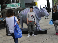 Persons are attending the inauguration of the 'Cowparade Mexico 2024' on Avenida Reforma in Mexico City, Mexico, on July 21, 2024. CowParade...