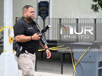 A crime scene investigator is scouring the area for clues following an overnight fatal shooting in Bronx, New York, United States, on July 2...