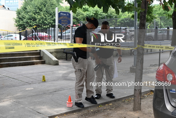 Crime scene investigators are placing evidence markers at the crime scene and are scouring the area for clues following an overnight fatal s...