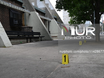 Evidence markers are being placed at the crime scene where shell casings are being discovered following an overnight fatal shooting in Bronx...