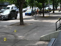 Evidence markers are being placed at the crime scene where shell casings are being discovered following an overnight fatal shooting in Bronx...