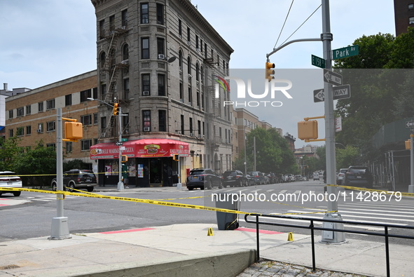 Evidence markers are being placed at the crime scene where shell casings are being discovered following an overnight fatal shooting in Bronx...