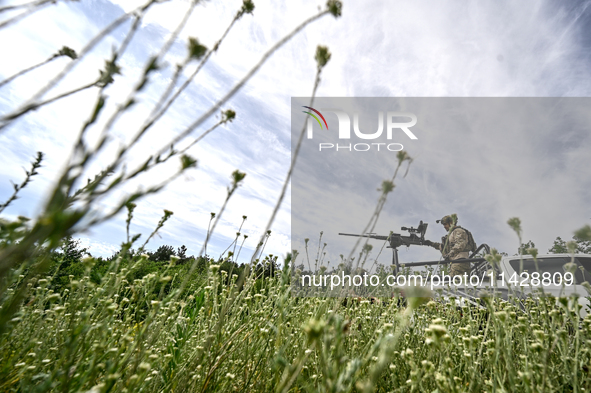 A fighter of the Separate Anti-Aircraft Machine Gun Battalion, who is providing air cover for the unmanned aerial vehicles and destroying ta...