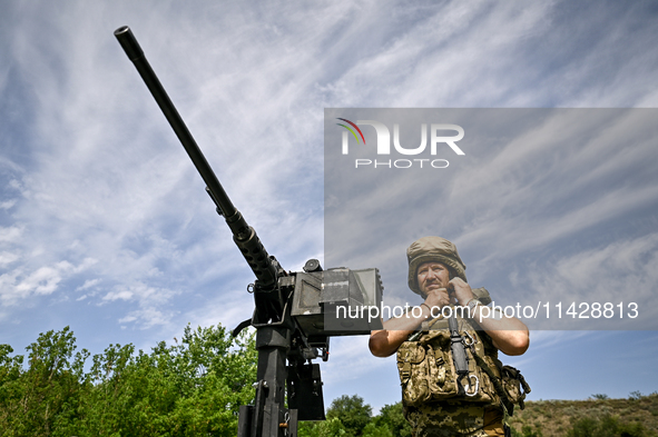 A fighter of the Separate Anti-Aircraft Machine Gun Battalion, who is providing air cover for the unmanned aerial vehicles and destroying ta...