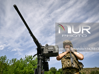 A fighter of the Separate Anti-Aircraft Machine Gun Battalion, who is providing air cover for the unmanned aerial vehicles and destroying ta...