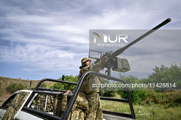 A fighter of the Separate Anti-Aircraft Machine Gun Battalion, who is providing air cover for the unmanned aerial vehicles and destroying ta...