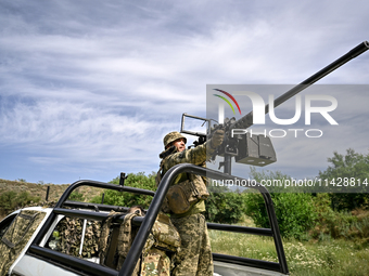 A fighter of the Separate Anti-Aircraft Machine Gun Battalion, who is providing air cover for the unmanned aerial vehicles and destroying ta...