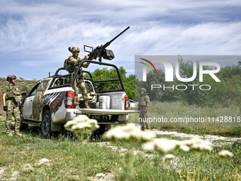 Fighters of the Separate Anti-Aircraft Machine Gun Battalion, who are providing air cover for unmanned aerial vehicles and destroying target...