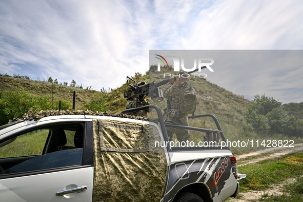 A fighter of the Separate Anti-Aircraft Machine Gun Battalion, who is providing air cover for the unmanned aerial vehicles and destroying ta...